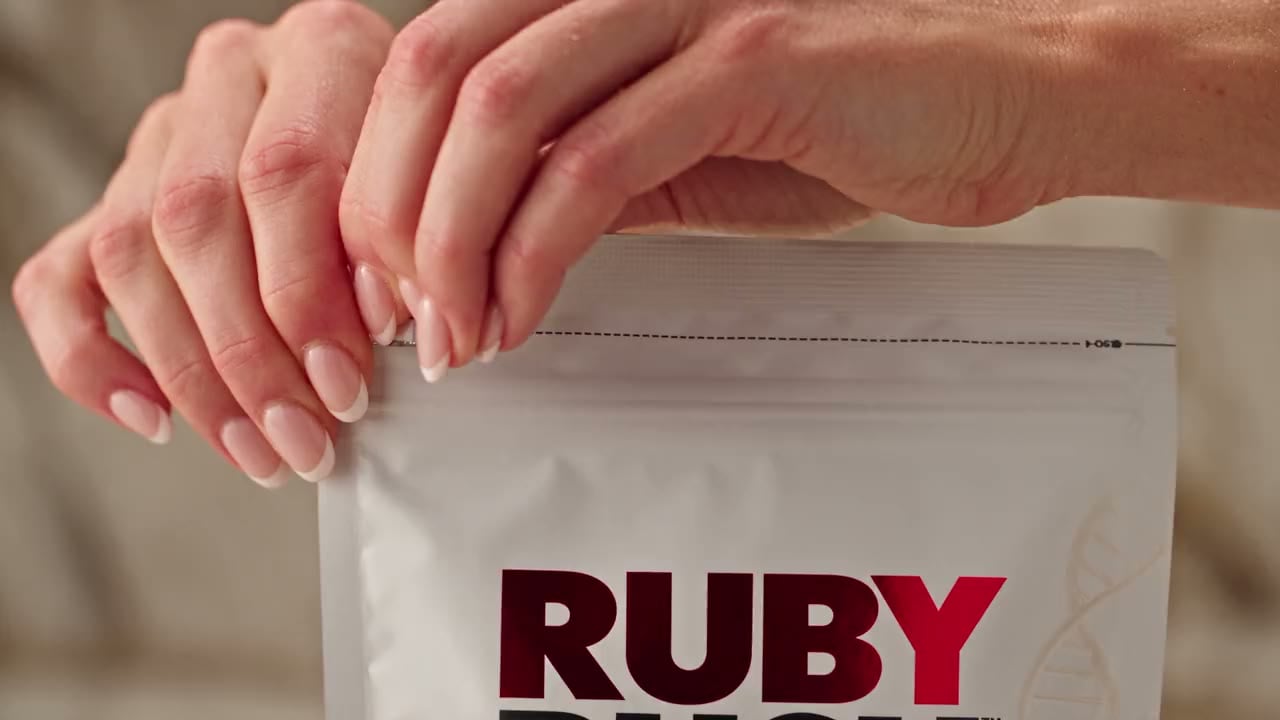 Hands opening a pouch of Ruby Rush